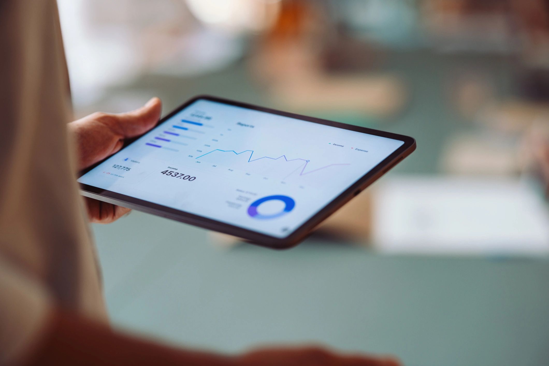 Tablet showing analytics charts and workflow-style reporting